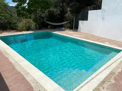 a swimming pool with blue water in a yard at Raconet Azul - Circuito Cataluña in Vallromanas