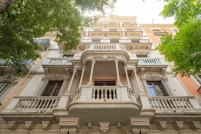 a tall building with a balcony on the side of it at Aspasios Market Balconies Apartments in Barcelona
