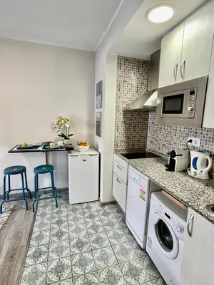 a kitchen with a washer and dryer at Sea Dreams with Amazing Terrace in Sitges