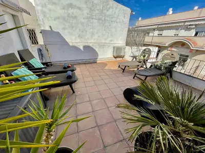 a patio with chairs and plants on a building at Sea Dreams with Amazing Terrace in Sitges