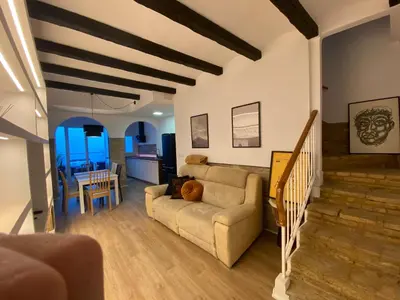 a living room with a couch and a table at Casa adosada a 20 min centro de Barcelona in Hospitalet de Llobregat