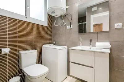 a bathroom with a toilet and a sink at Magical Design With Terrace in Hospitalet de Llobregat
