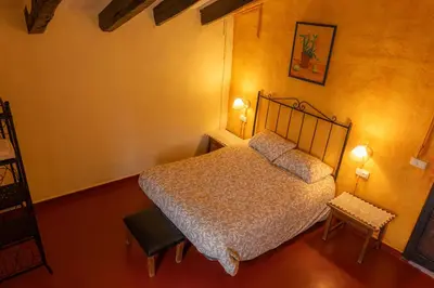 a bedroom with a bed with two pillows on it at Masia en plena naturaleza y tranquilidad in San Quintín de Mediona