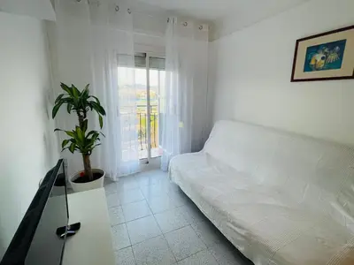 a white room with a couch and a window at Barca 1 in Sant Adria de Besos