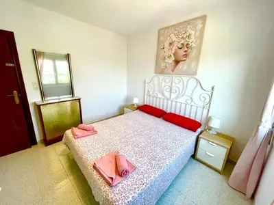 a bedroom with a bed with two pink towels on it at Barca 1 in Sant Adria de Besos