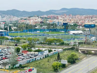 a city with cars parked in a parking lot at Barca 1 in Sant Adria de Besos