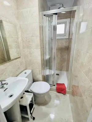 a bathroom with a toilet and a shower and a sink at Barca 1 in Sant Adria de Besos