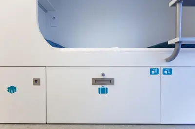 a row of lockers in a room with a mirror at Dream Cube Hostel in Barcelona
