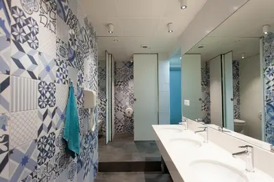 a bathroom with two sinks and blue and white tiles at Dream Cube Hostel in Barcelona