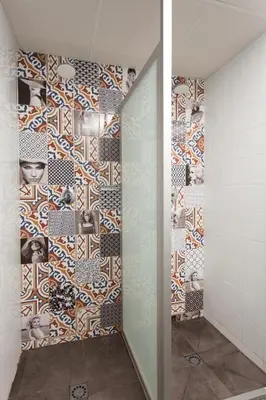 a bathroom with a shower with a mosaic wall at Dream Cube Hostel in Barcelona