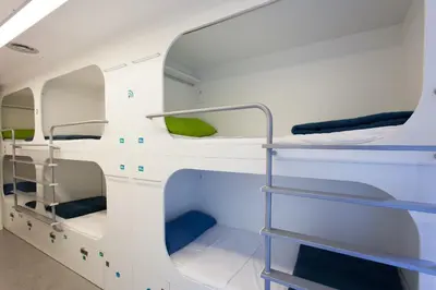 a room with bunk beds on a boat at Dream Cube Hostel in Barcelona