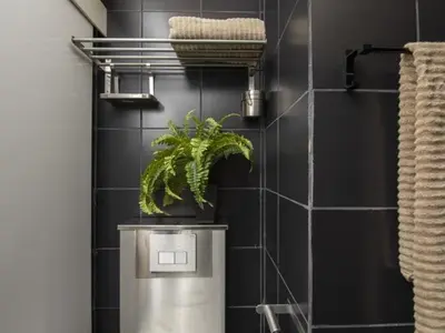 a bathroom with a plant on top of a trash can at Attic Apartment 468 Sagrada Familia in Barcelona