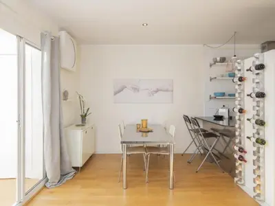 a white room with a table and a dining room at Attic Apartment 468 Sagrada Familia in Barcelona