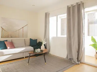 a living room with a white couch and a table at Attic Apartment 468 Sagrada Familia in Barcelona
