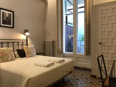 a bedroom with a bed with two towels on it at Casa Consell Bailen, Guest House in Barcelona