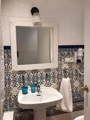 a bathroom with a sink and a mirror at Casa Consell Bailen, Guest House in Barcelona