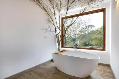 a bath tub in a bathroom with a window at Cabaña del Bosque in Canyelles