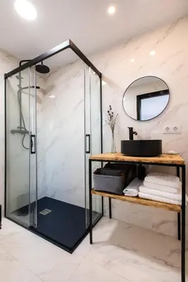 a bathroom with a glass shower and a sink at Cabaña del Bosque in Canyelles