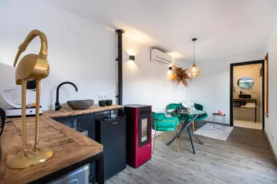 a kitchen with a counter and a table in a room at Cabaña del Bosque in Canyelles