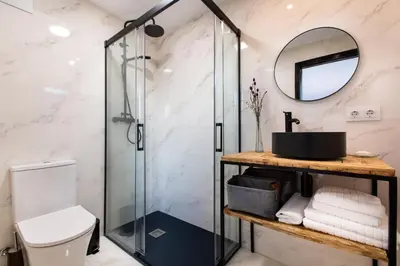 a bathroom with a glass shower and a sink at Cabaña del Bosque in Canyelles