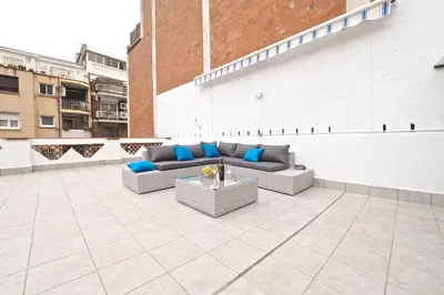 a patio with couches and a table on a building at Bed&BCN Park Güell in Barcelona