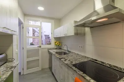 a kitchen with a sink and a counter top at Bed&BCN Park Güell in Barcelona