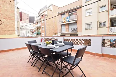 a black table and chairs sitting on a patio at Bed&BCN Park Güell in Barcelona