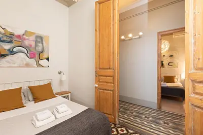 a bedroom with a bed with two towels on it at Casa Maca Guest House in Barcelona