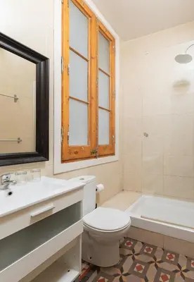 a bathroom with a toilet and a sink and a tub at Casa Maca Guest House in Barcelona