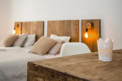 a bedroom with a bed and a table with a cup at Casa Maca Guest House in Barcelona