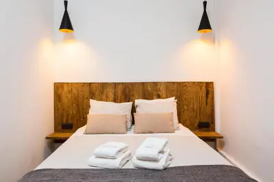 a bedroom with a bed with towels on it at Casa Maca Guest House in Barcelona