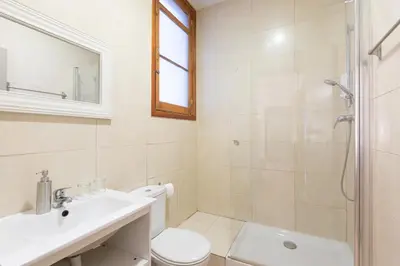 a bathroom with a sink and a toilet and a shower at Casa Maca Guest House in Barcelona