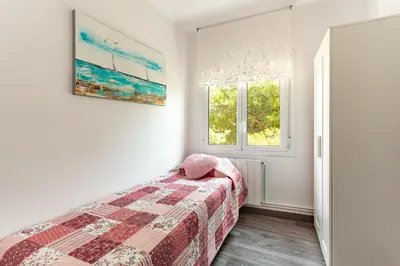 a bedroom with a bed and a window at Barca 3 New Lovely aprtment Near Beach in Sant Adria de Besos