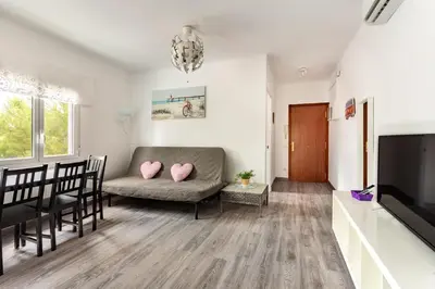 a living room with a couch and a television at Barca 3 New Lovely aprtment Near Beach in Sant Adria de Besos
