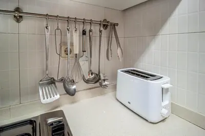 a kitchen with a toaster and utensils on the wall at Apartamento zona Sagrada Familia in Barcelona