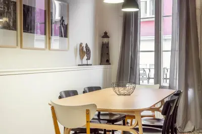 a dining room with a wooden table and chairs at Casa Cosi - Putxet 3 in Barcelona