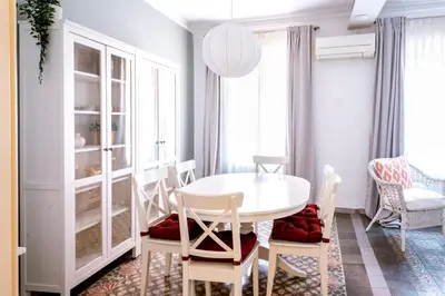 a dining room with a white table and chairs at Casa Cosi - Sant Gervasi 3 in Barcelona
