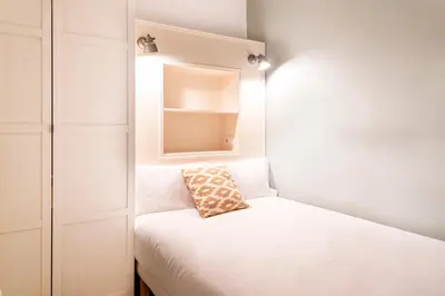 a small room with a bed with a pillow on it at Casa Cosi - Sant Gervasi 3 in Barcelona