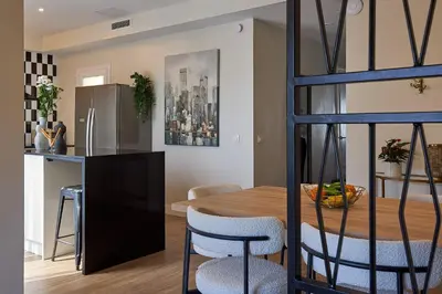 a kitchen and dining room with a wooden table and chairs at Casa Cosi - Terrace 1 in Barcelona