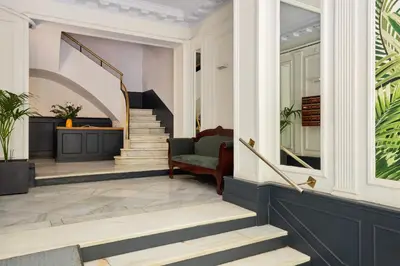 a living room with stairs and a chair at Casa Cosi - Terrace 1 in Barcelona