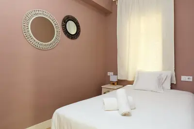 a bedroom with a bed with two towels on it at Casa Cosi - Casanova 6 in Barcelona