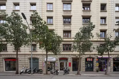a large building with motorcycles parked in front of it at Casa Cosi - Casanova 6 in Barcelona