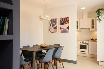 a kitchen and dining room with a table and chairs at Casa Cosi - Terrace 2 in Barcelona