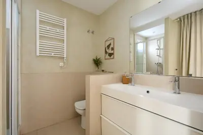 a bathroom with a sink and a toilet and a mirror at Casa Cosi - Terrace 2 in Barcelona