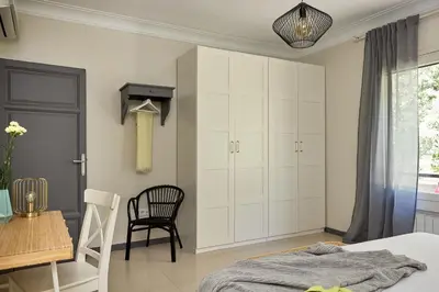 a bedroom with a bed and a table and a chair at Casa Cosi - Casanova 1 in Barcelona