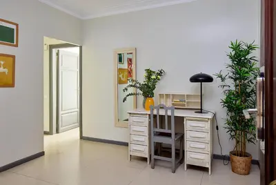 a room with a desk with a chair and plants at Casa Cosi - Casanova 1 in Barcelona