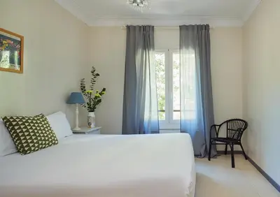 a bedroom with a white bed and a window at Casa Cosi - Casanova 1 in Barcelona