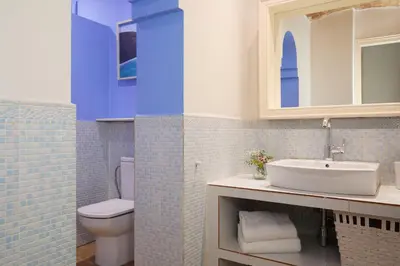 a bathroom with a white sink and a toilet at Casa Cosi - Patio 2 in Barcelona