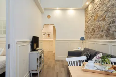 a living room with a couch and a table at Casa Cosi - Patio 2 in Barcelona