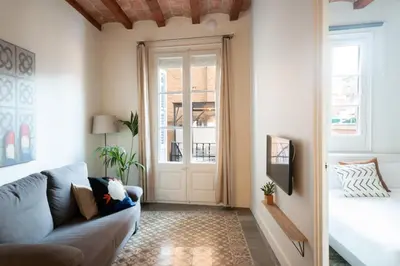 a living room with a couch and a door at Casa Cosi - Putxet 1 in Barcelona